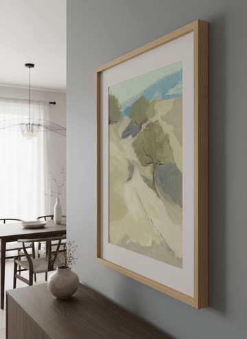 Wall art styled above a dining table in a contemporary home
