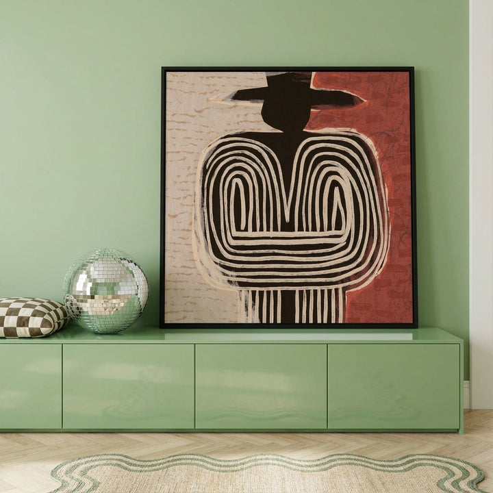 Canvas wall art with a black surround standing on a sideboard in a colourful eclectic bedroom