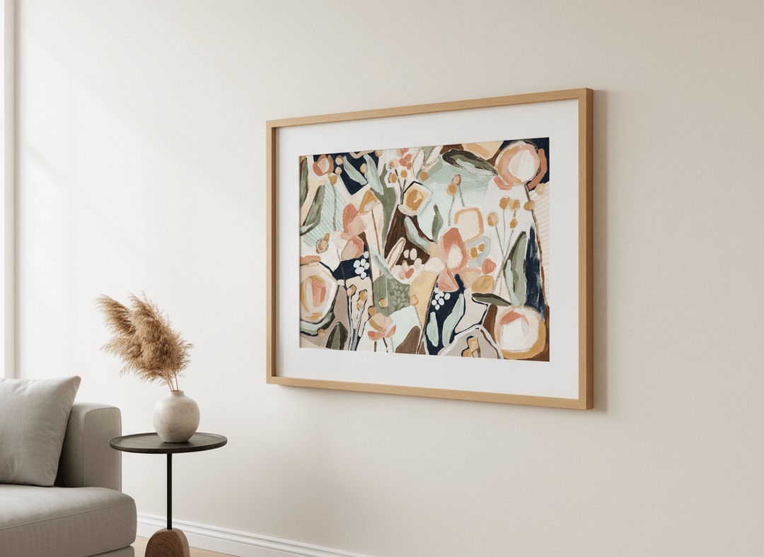 Modern wall art styled above a sofa in a neutral living room