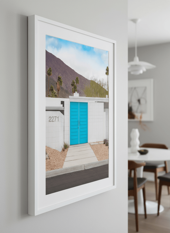 Wall art styled above a dining table in a contemporary home