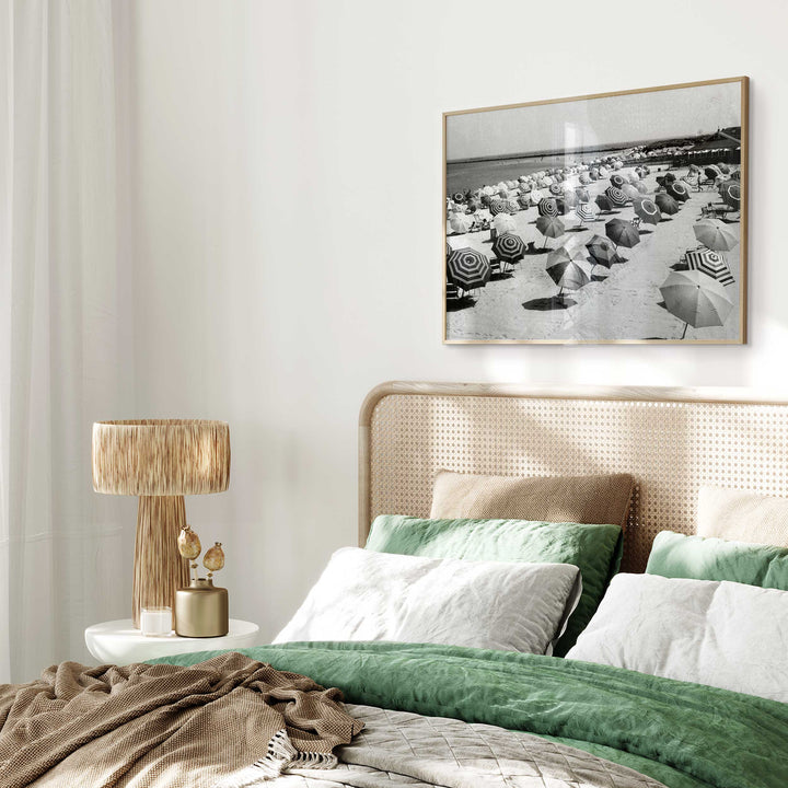 black and white umbrella coastal photography wall art above bed