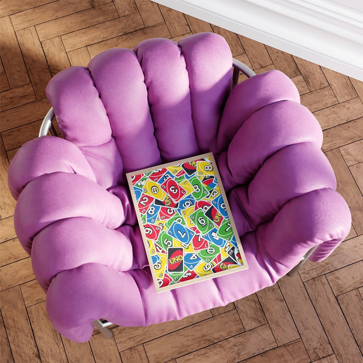 Purple cushioned chair with a colorful Uno artwork on a wooden floor
