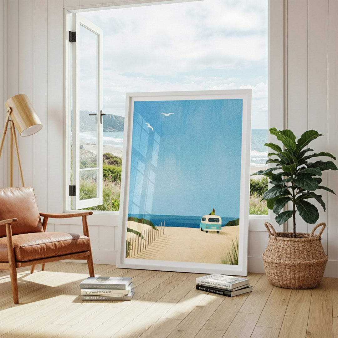 artwork of a beach scene in a modern living room with a leather chair and plant.