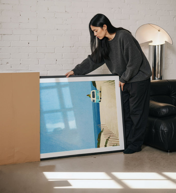 Person holding picture in a living room setting
