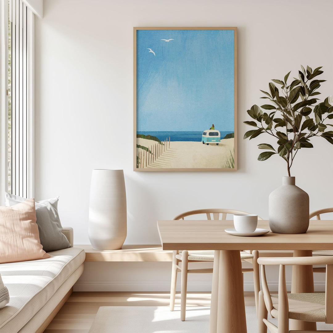 Modern living room with a beach scene painting on the wall, a table with a plant, and a sofa.