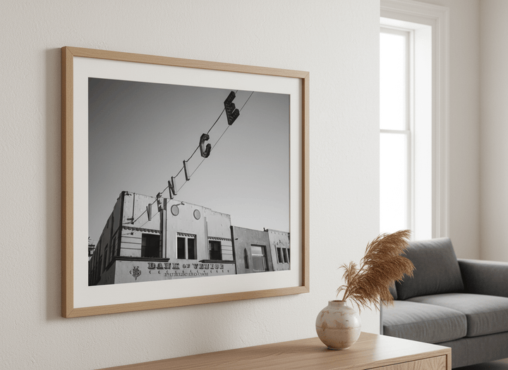 Modern wall art styled above a sofa in a neutral living room