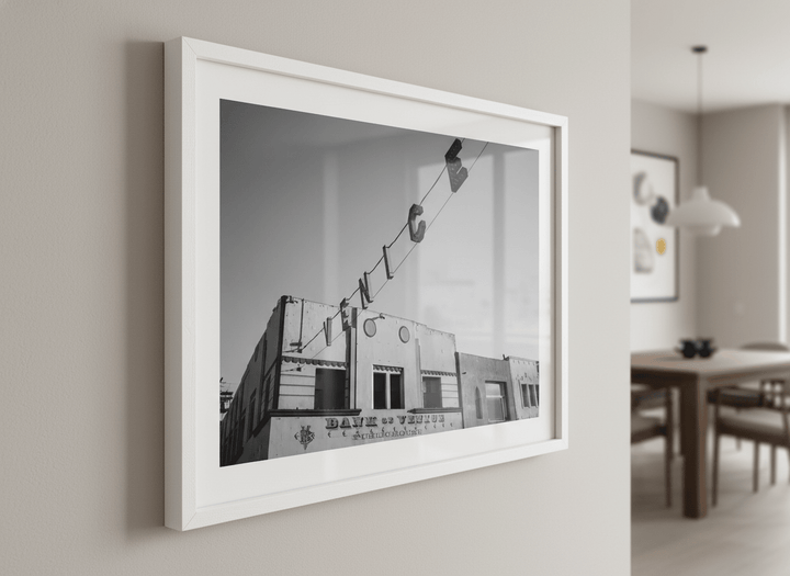 Wall art styled above a dining table in a contemporary home