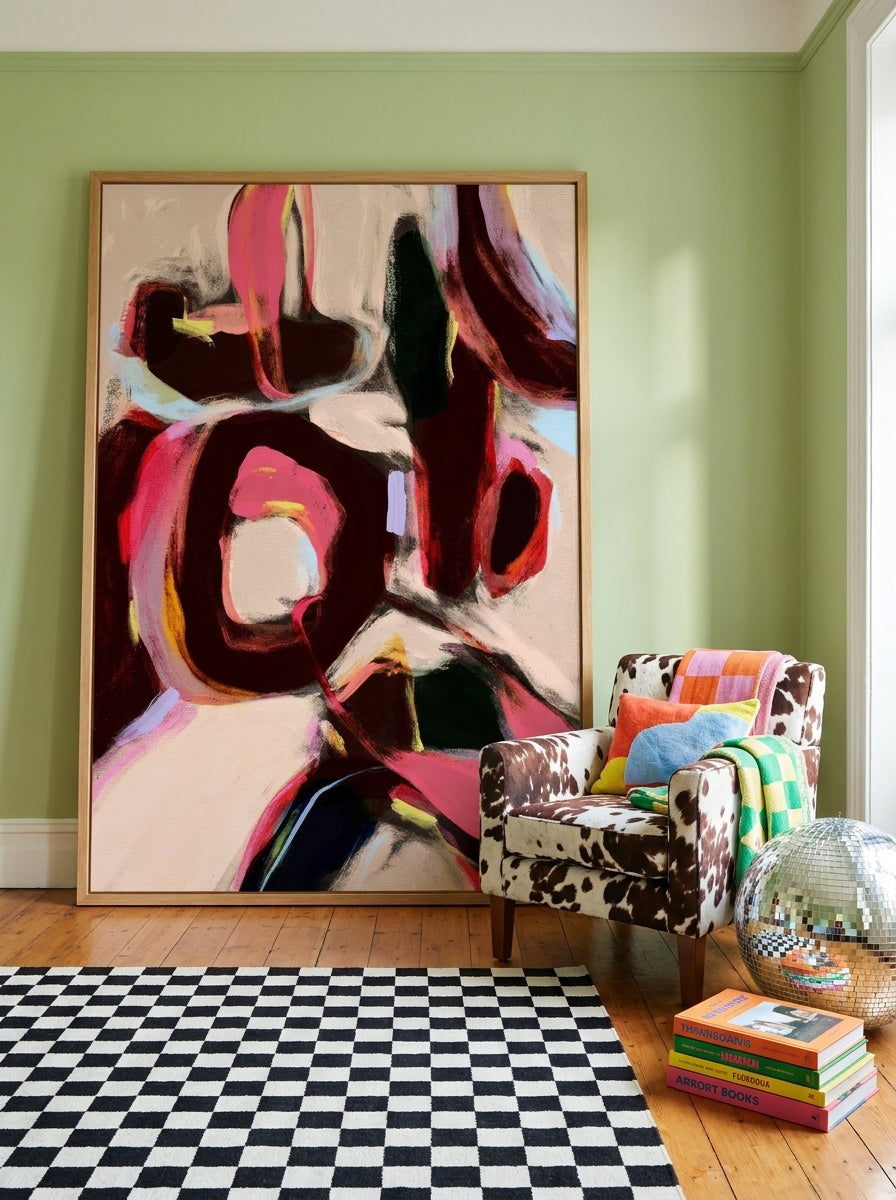 Oversized statement modern wall art print leaning against the wall in a colourful eclectic dining room