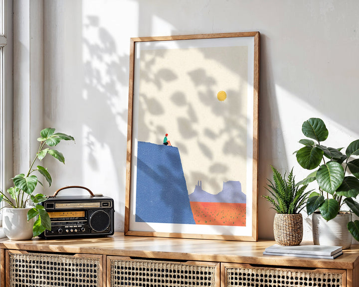 Abstract artwork on a wooden console table with plants and a radio.