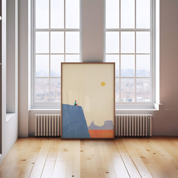 Artwork on a wooden floor with large windows in the background