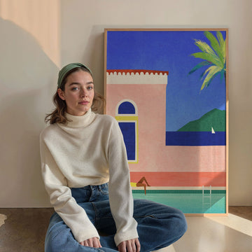 Woman sitting in front of a colorful abstract painting on a wall.
