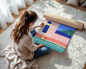 Woman unrolling a colorful poster on a carpeted floor