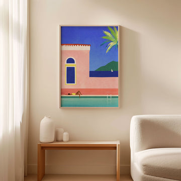 Artwork of a beach scene on a wall above a side table with decorative items.