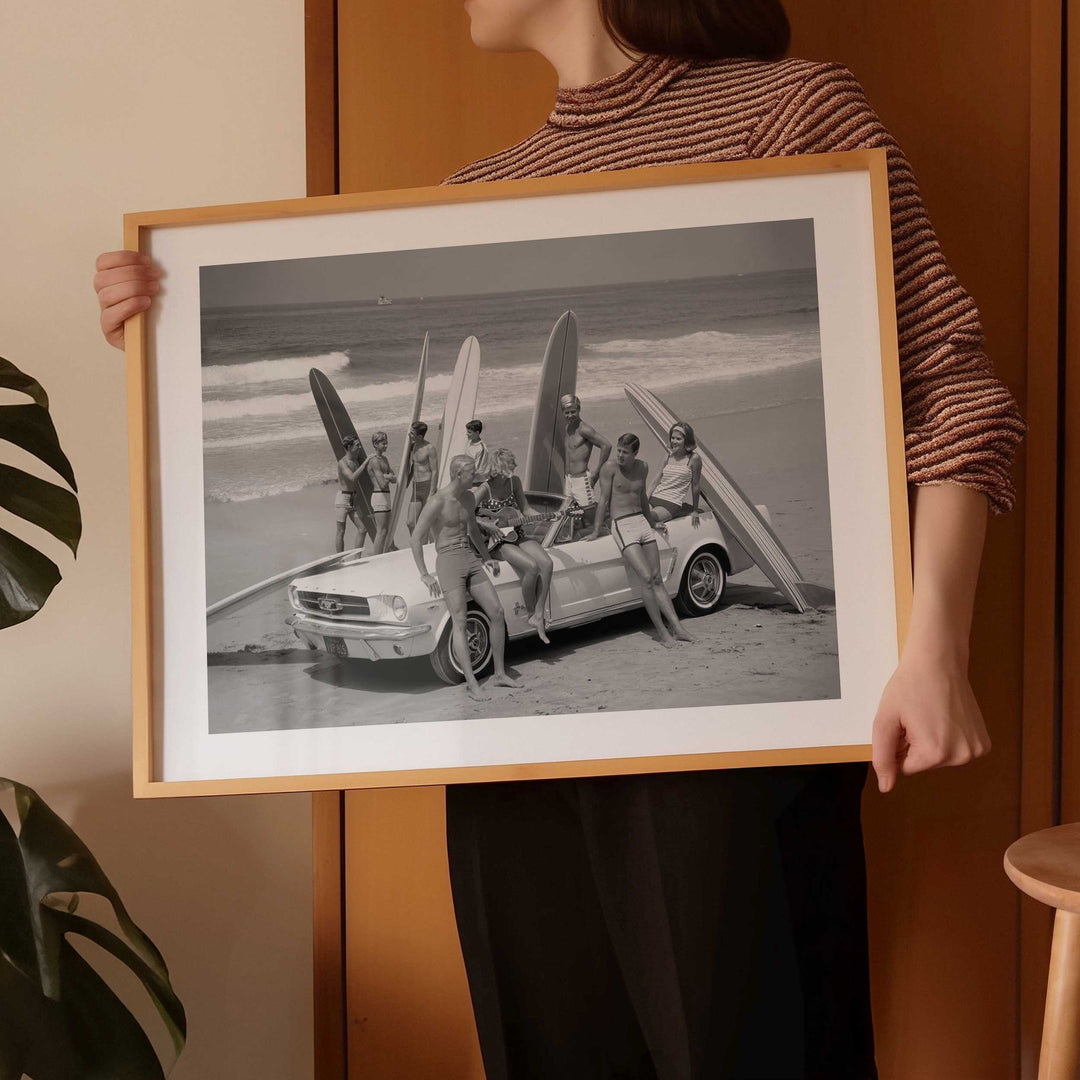 Girl holding vintage surfer wall art