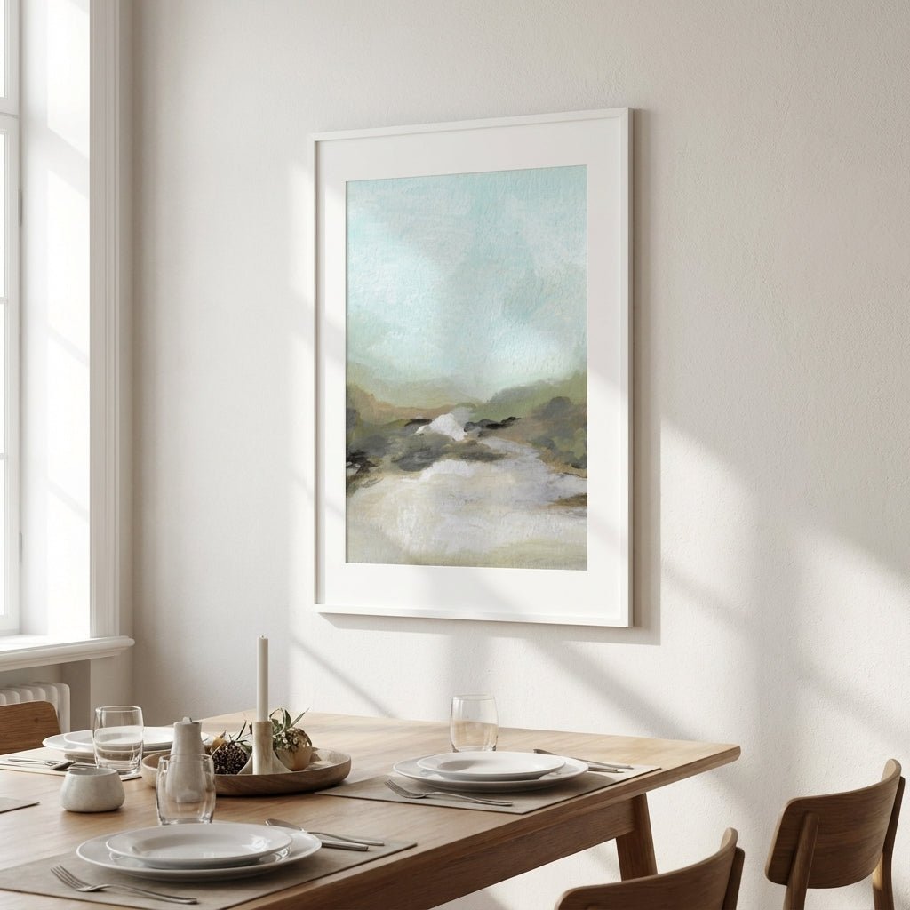 abstract artwork on a wall above a dining table with plates and glasses.