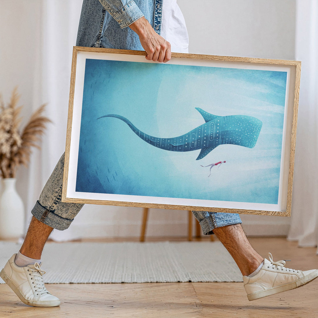 Person holding artwork of a whale underwater scene