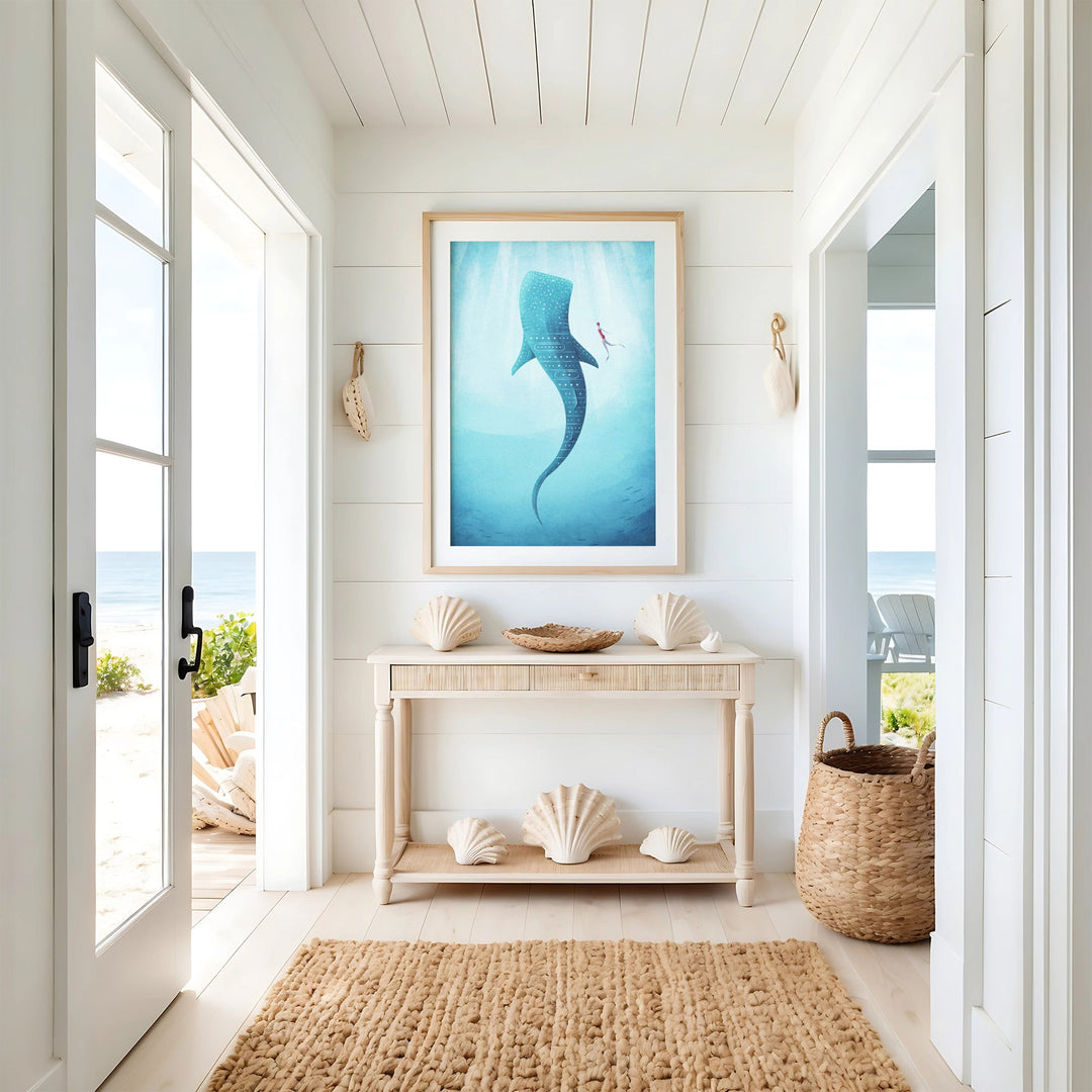 Artwork of a whale in a coastal room with shell decor and a view of the ocean.