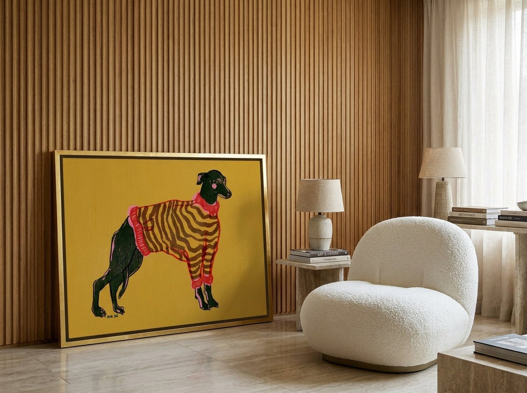 Canvas wall art with a gold leaf surround leaning against the wall in a luxe living room