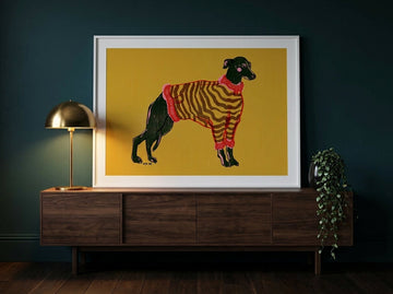 Modern wall art print standing on a sideboard in a moody living room
