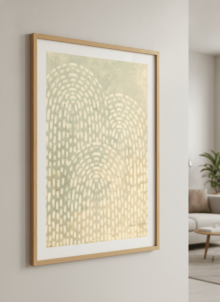 Modern wall art styled above a sofa in a neutral living room