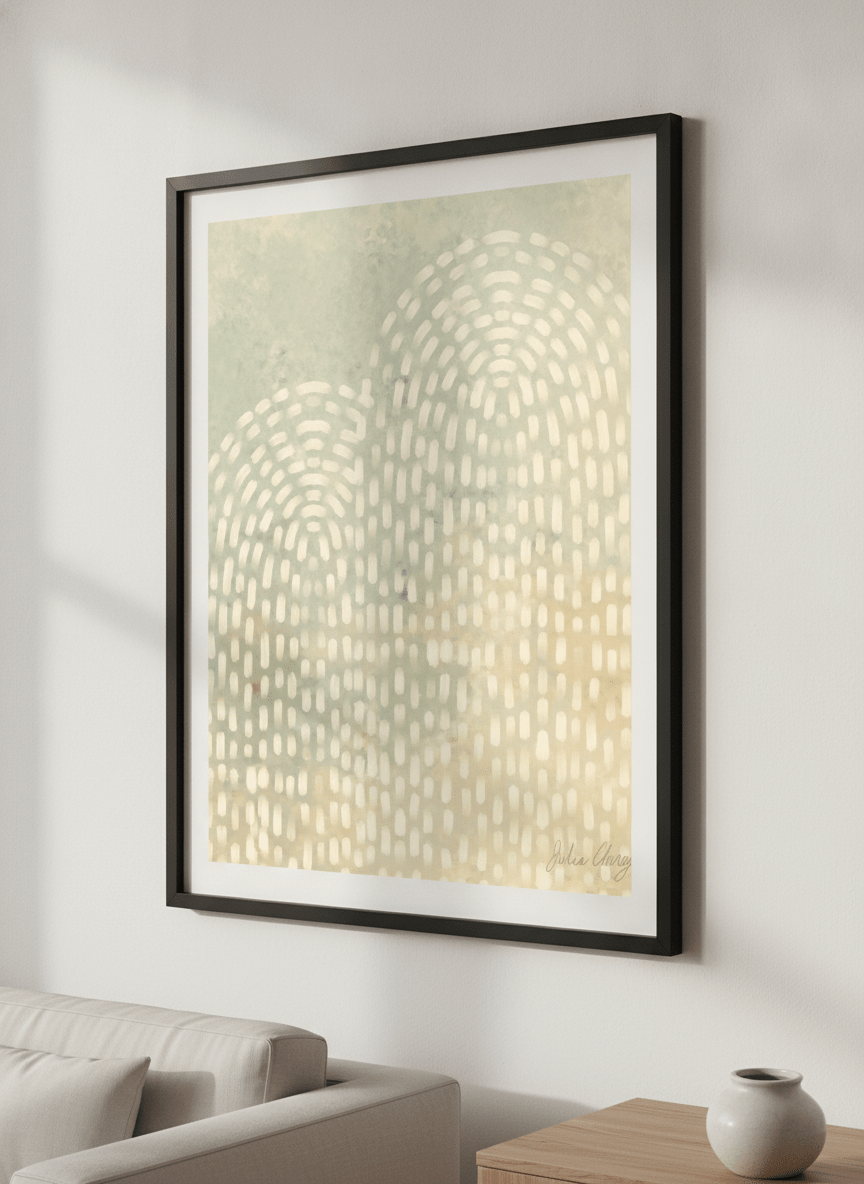 Modern wall art styled above a sofa in a neutral living room