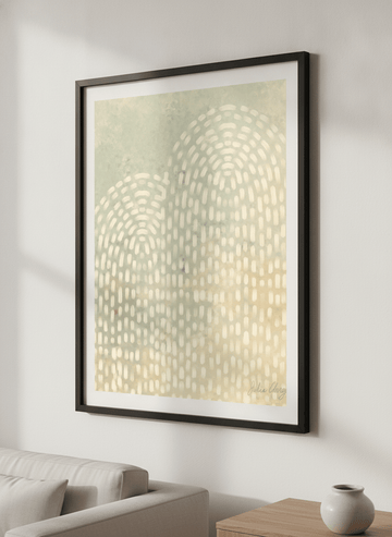 Modern wall art styled above a sofa in a neutral living room