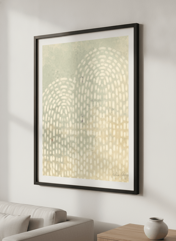 Modern wall art styled above a sofa in a neutral living room