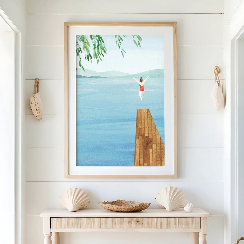 Nautical-themed interior with a console table, seashells, and a beach scene painting.