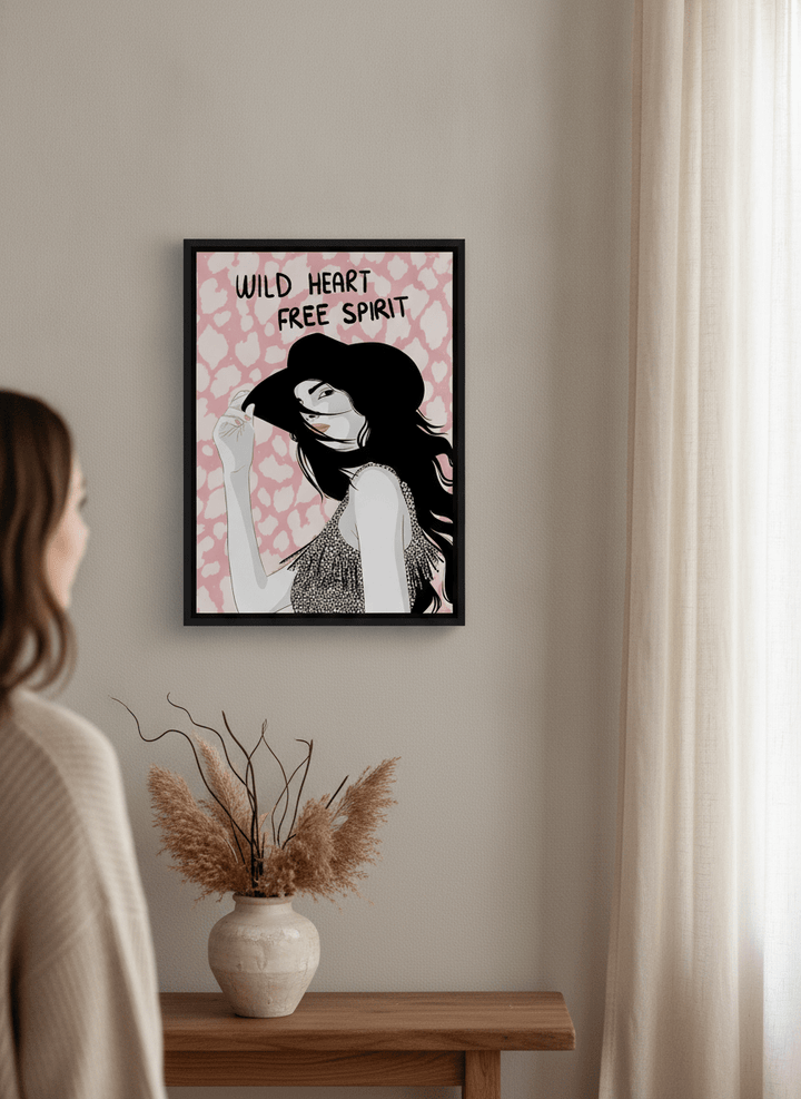 Person holding canvas wall art with a black surround in a warm Japandi living room
