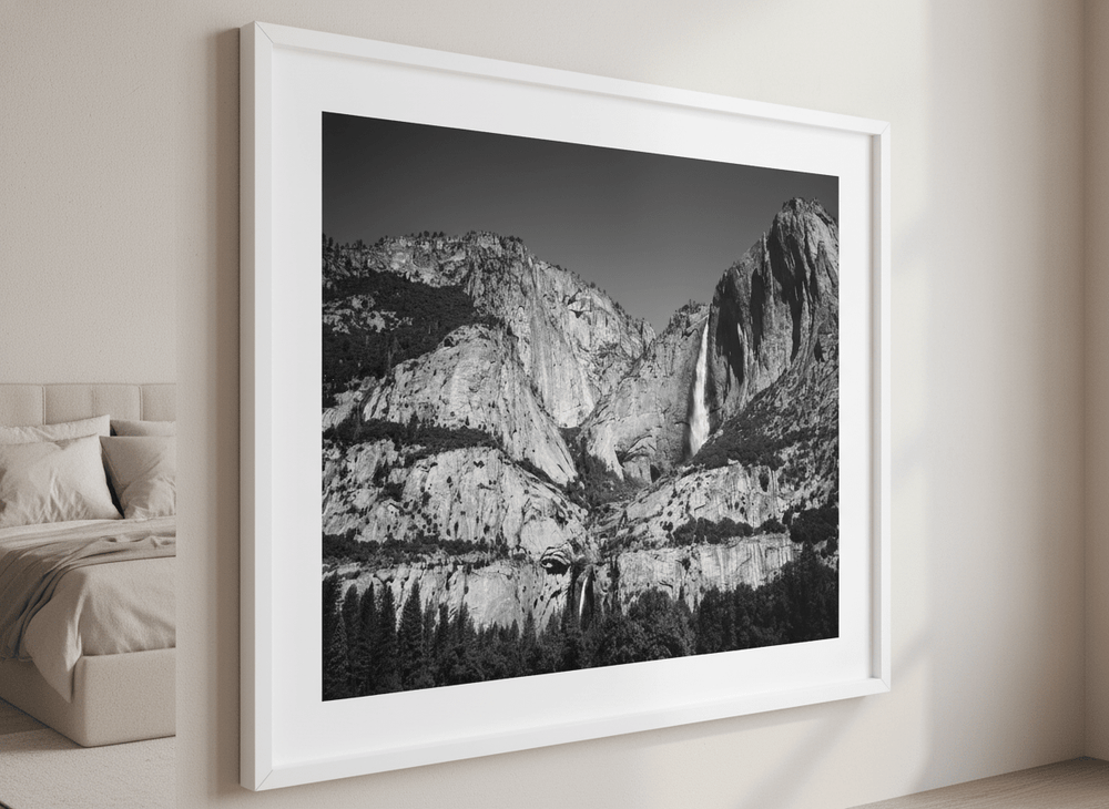 Minimalist artwork displayed in a calm, light-filled bedroom interior