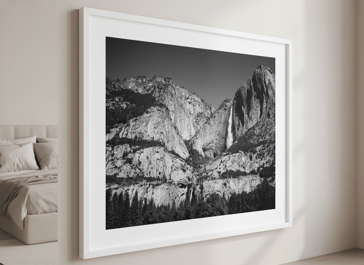 Minimalist artwork displayed in a calm, light-filled bedroom interior